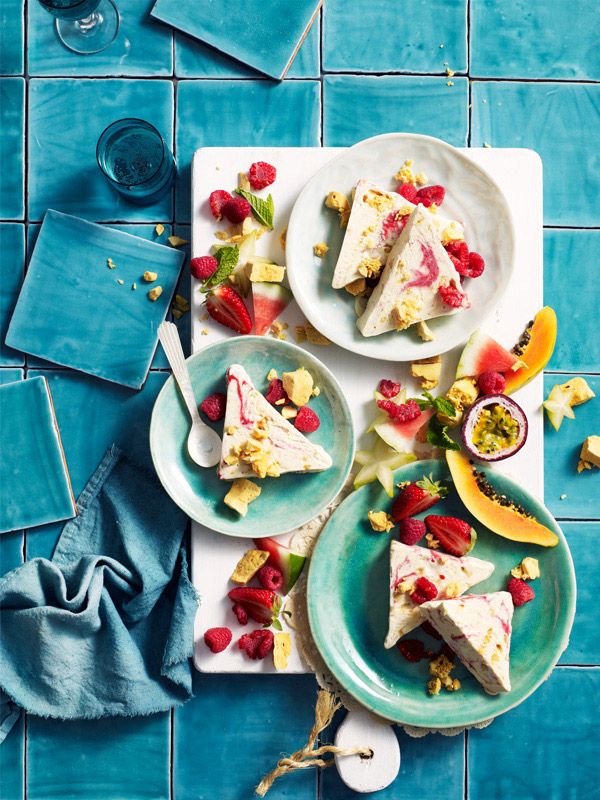 there are three plates with desserts on them next to glasses and utensils