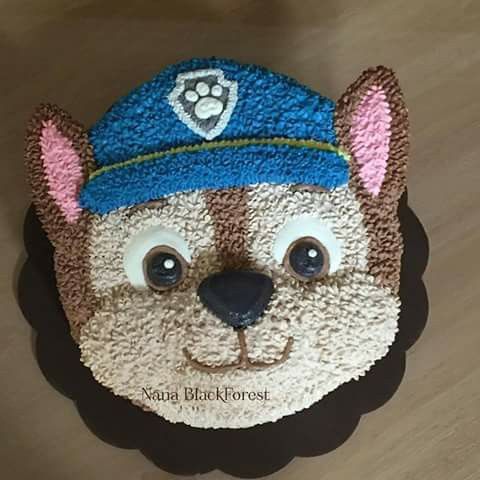 a cake made to look like a bear wearing a hat