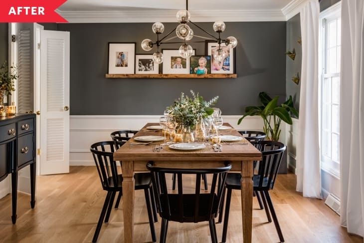 the dining room table is set with place settings for four people, and there are pictures on the wall above it