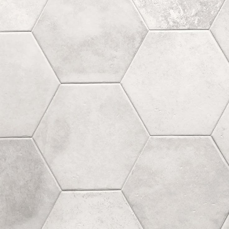 white hexagonal tiles are arranged on the floor