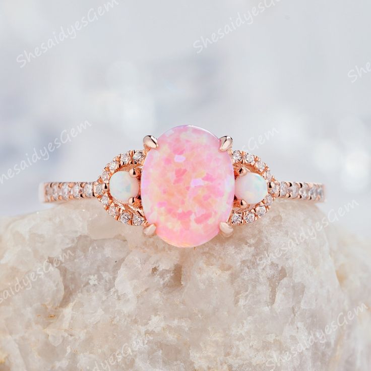 A classical vintage oval opal ring in 10K 14k or 18k gold, pictured in rose gold. Unique oval cut pink fire opal engagement ring, wedding ring, anniversary ring gift for girl, women, best friend, wife and her. The opal is a representative of justice and harmony, and is a protective stone in dangerous places.  ITEM DESCRIPTION ★Center Stone: 0.8 Carat 8x6mm Oval Cut Lab Pink Fire Opal ★Side Stone: 2mm round cut lab created white opal  ★Accent Stone:0.18CT Diamonds or Moissanite   Accent Stone: Cubic Zircon with Silver Ring ★Shank Width(Bottom):1.5mm *Purchase Guarantee: 1: Provide you with the best service. 2: 30 Days Refund Guarantee. 3: Free Gift Box and Packing. *Processing time: When we receive payment We need 2-3 weeks to work for your items in perfect by hand. Please contact us if you Pink Fire, Opal Wedding, Cute Engagement Rings, Future Engagement Rings, Opal Wedding Rings, Promise Ring Gift, Opal Engagement, Engagement Rings Opal, Dream Engagement Rings