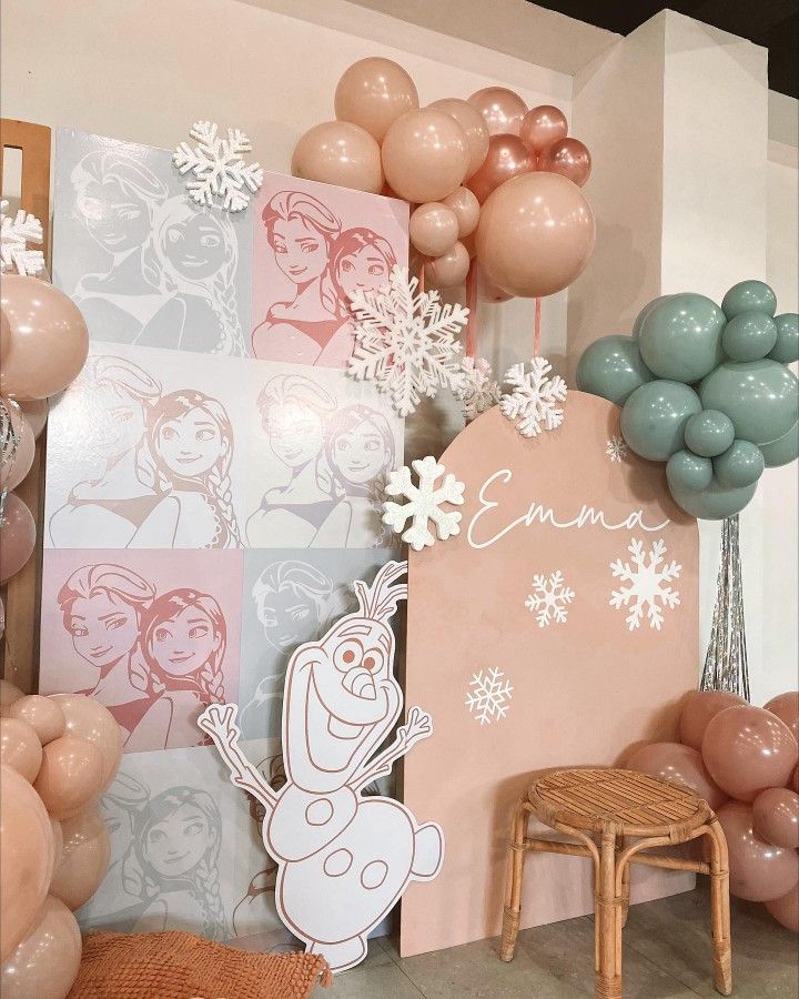 balloons and decorations are displayed on the wall in front of a frozen princess themed room