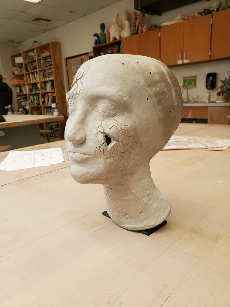 a white head sitting on top of a wooden table