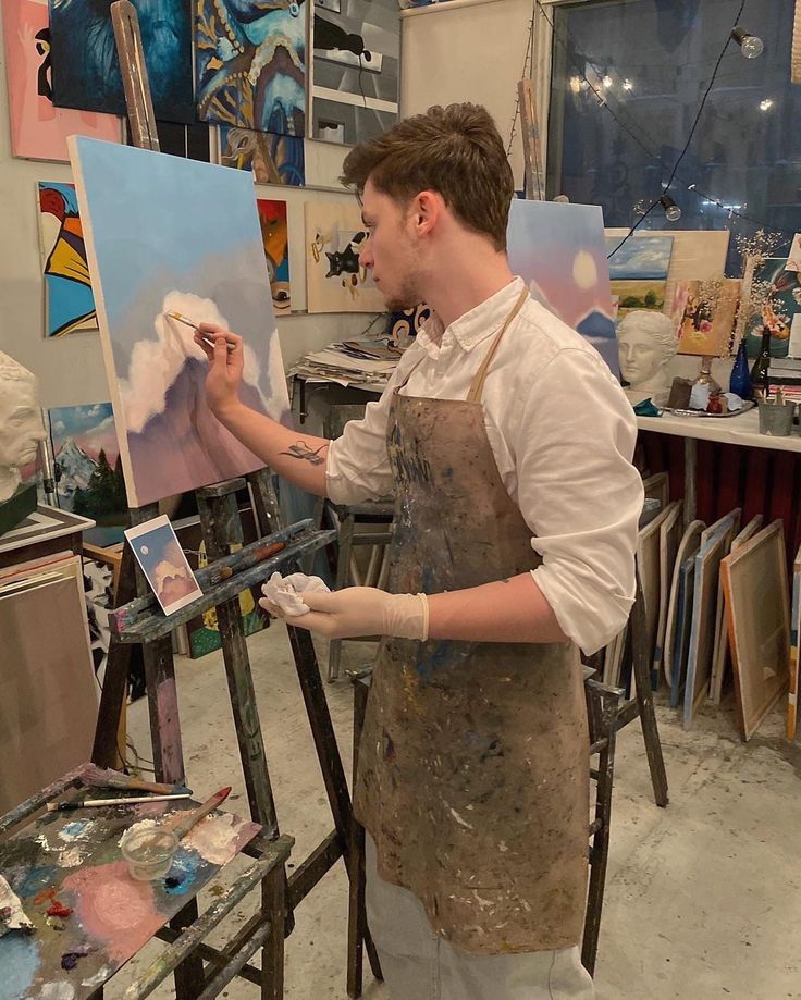 a man is painting in an art studio