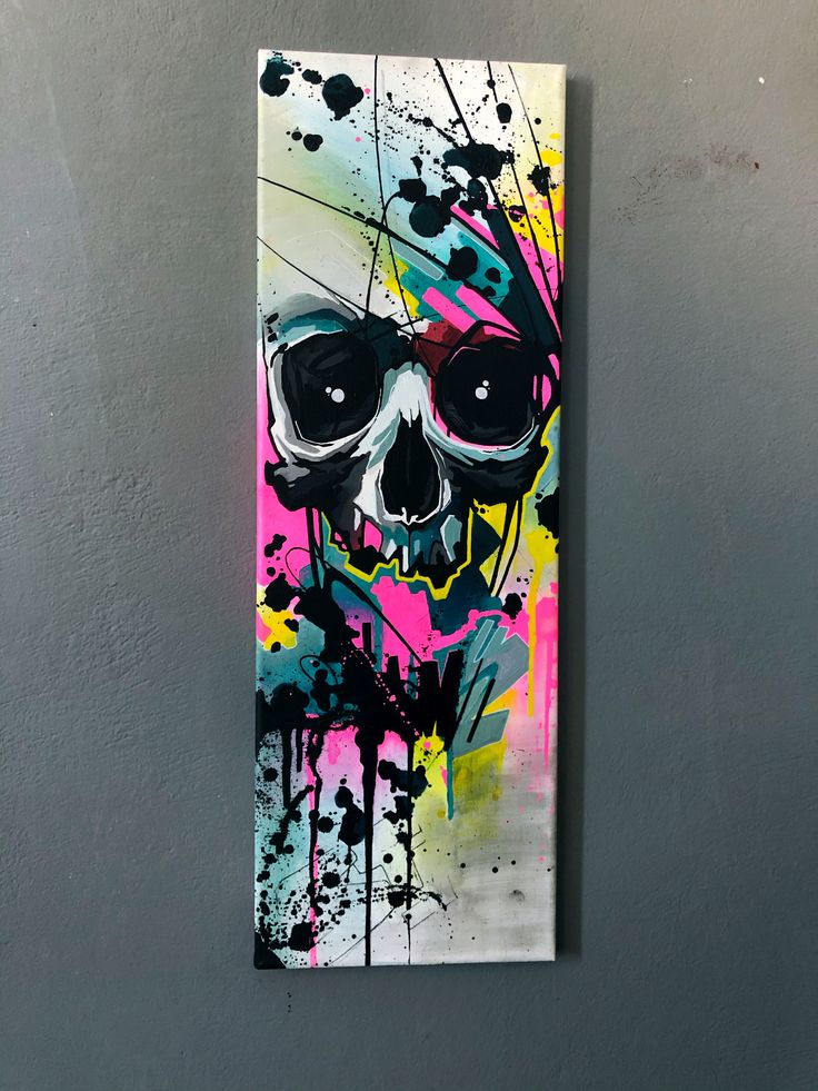 a painting on a wall with a skull painted on it's face and glasses