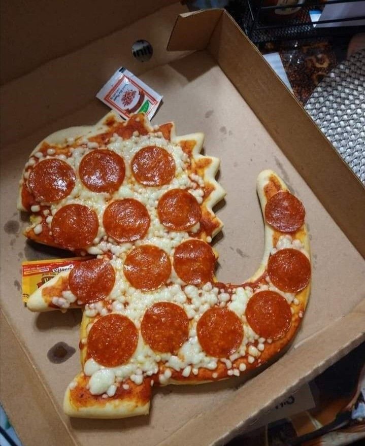 a pizza shaped like the letter j is in a box with pepperoni and cheese