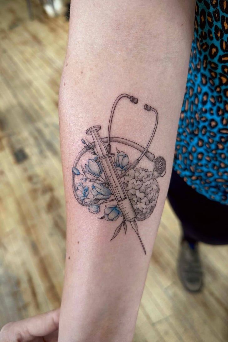 a tattoo on the arm of a woman with a stethoscope and flowers