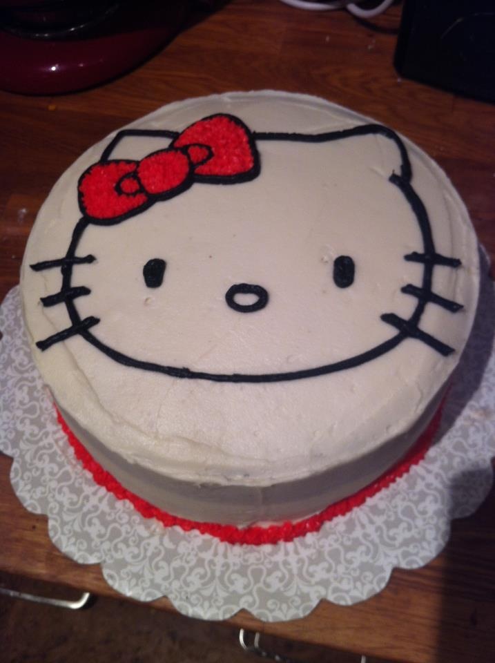 a hello kitty cake is sitting on a doily