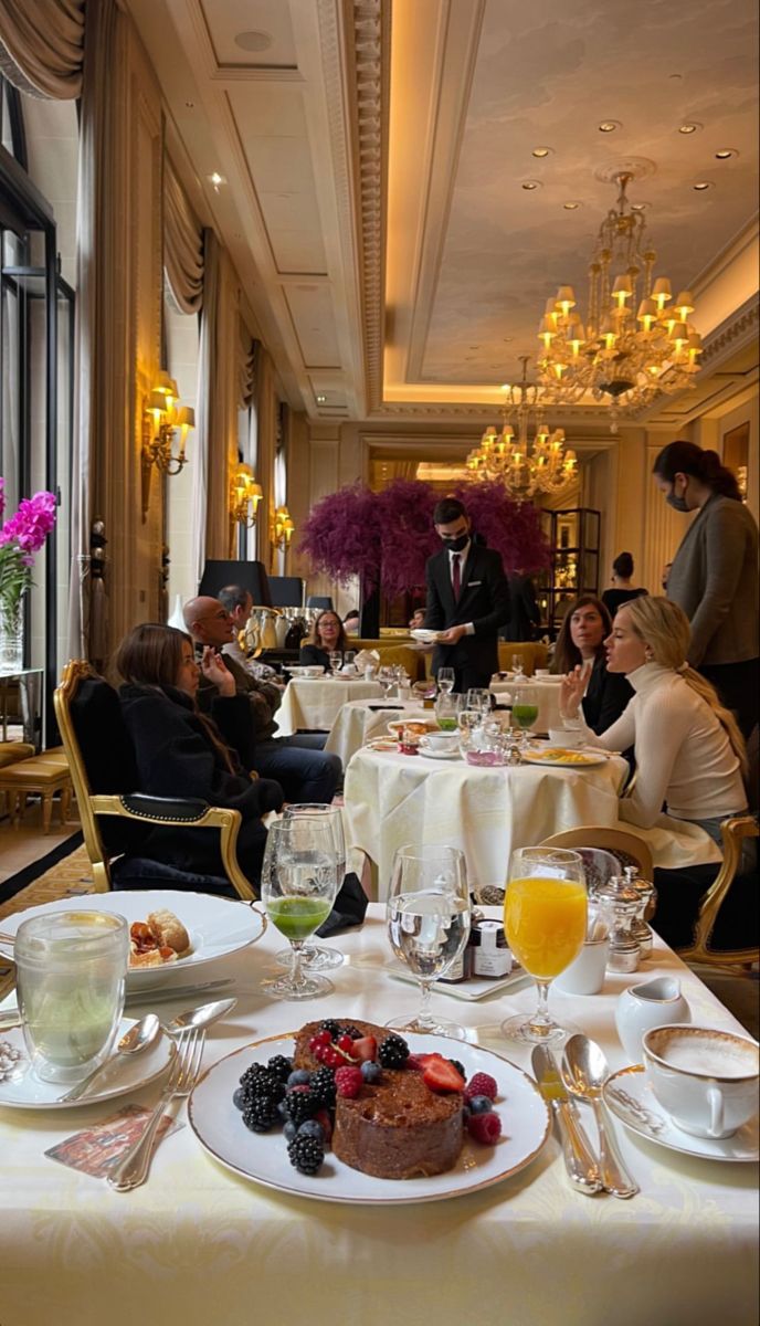 people sitting at tables in a fancy restaurant