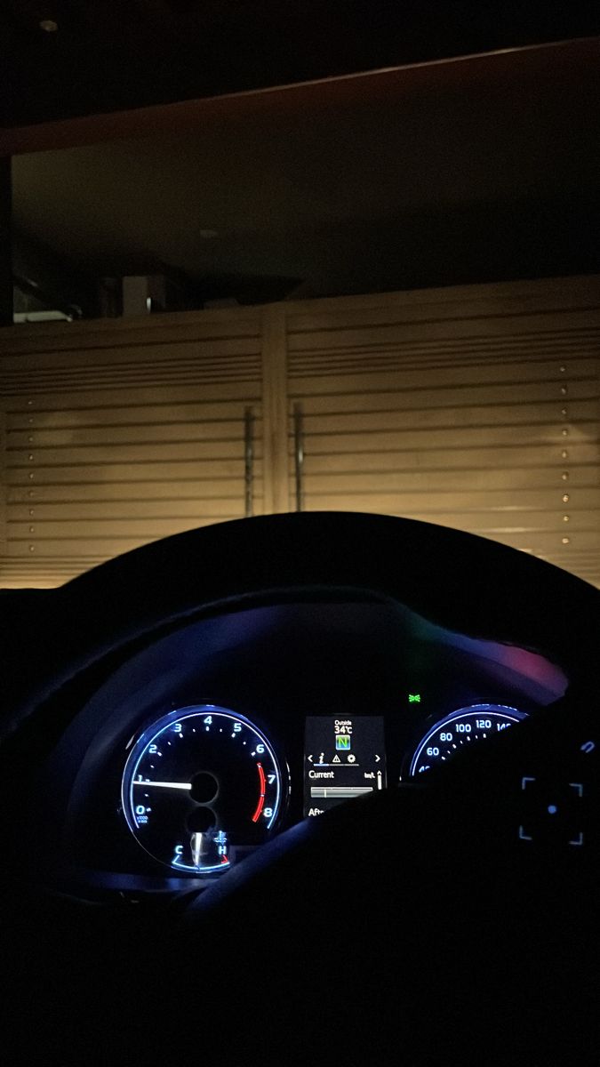 the interior of a car is lit up at night with blue lights and white shutters