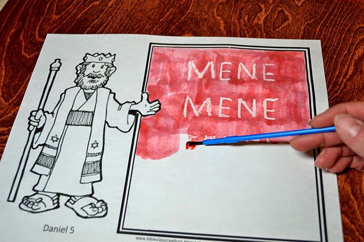 a hand holding a blue marker over a piece of paper that says mene meme