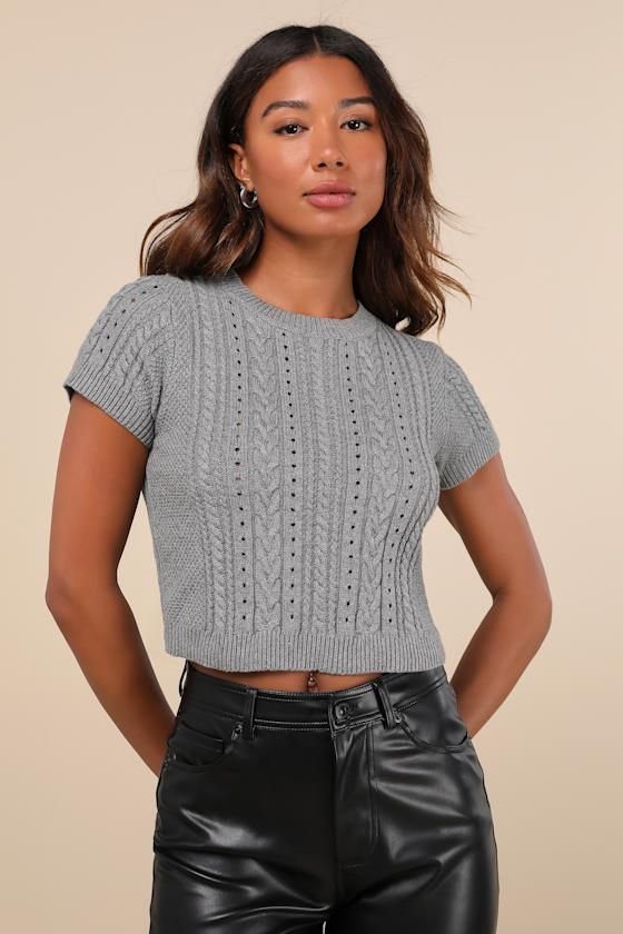 Your autumn style will be truly special with a trendy must-have like the Lulus Modish Ways Heather Grey Cable Knit Short Sleeve Sweater Top! This soft and stretchy sweater (with a subtle heathered effect throughout) boasts a variety of classic designs, including cable, seed, and ribbed knit textures (plus pierced detailing), that makes this piece truly unique. A timeless crew neckline and a fitted, cropped bodice are framed by cute short sleeves, while contrasting ribbed knit trim at the necklin Trendy Gray Knit Top With Crew Neck, Trendy Gray Crew Neck Knit Top, Trendy Gray Stretch Knit Top, Trendy Stretch Gray Knit Top, Trendy Solid Cable Knit Top, Gray Stretch Textured Knit Tops, Trendy Solid Color Cable Knit Tops, Fitted Cable Knit Cropped Sweater For Layering, Trendy Textured Knit Cozy Fit Top