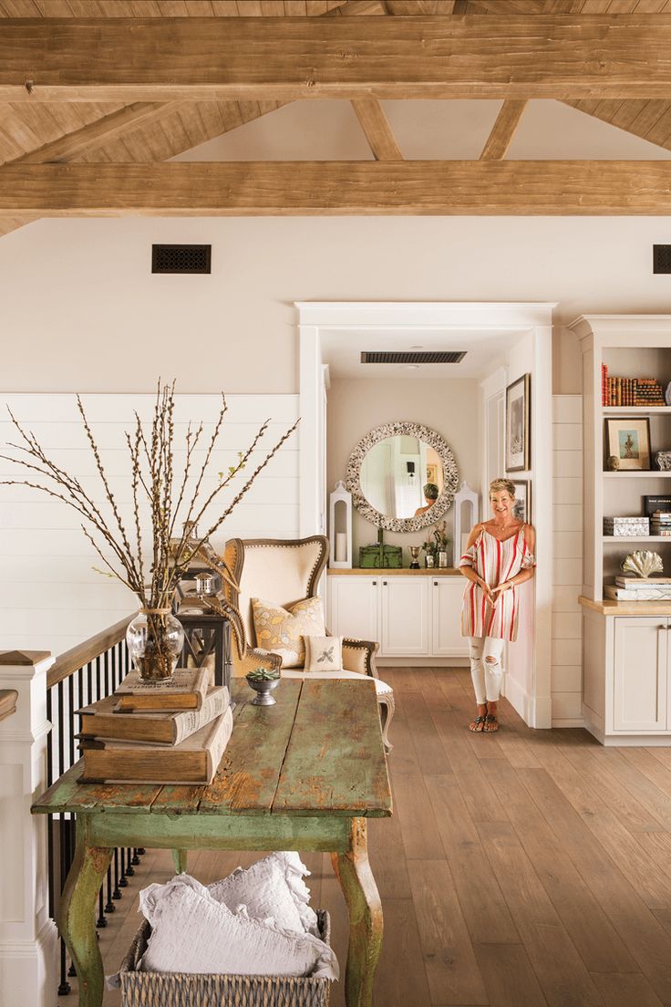 a woman is standing in the living room