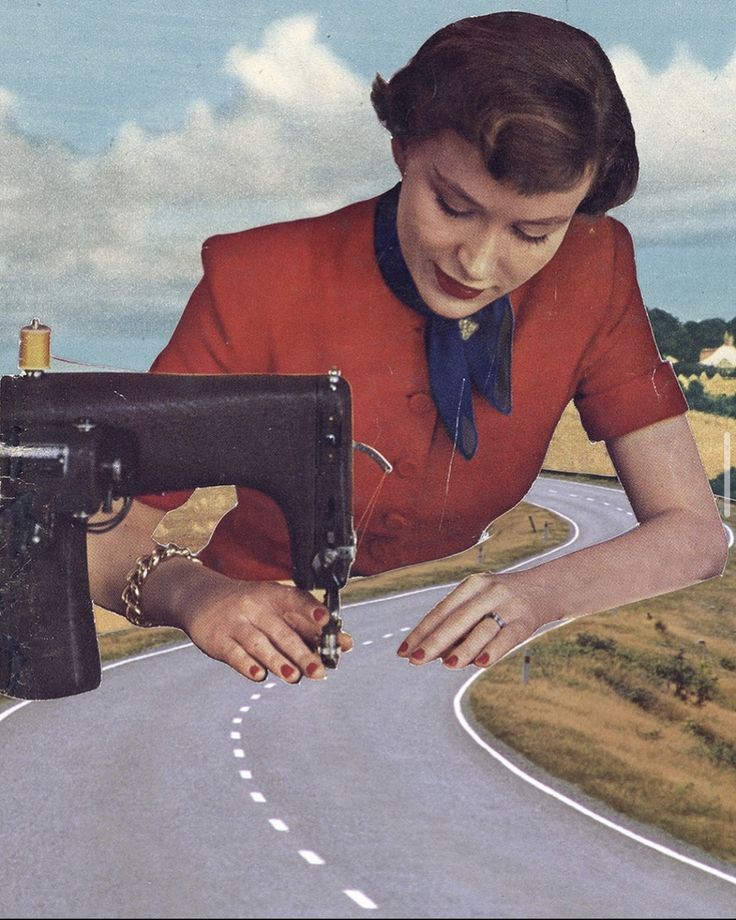 a woman is holding a sewing machine on the road