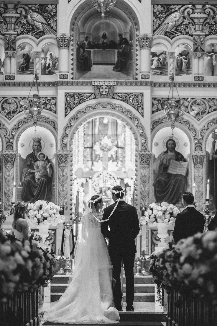 the bride and groom are standing at the alter