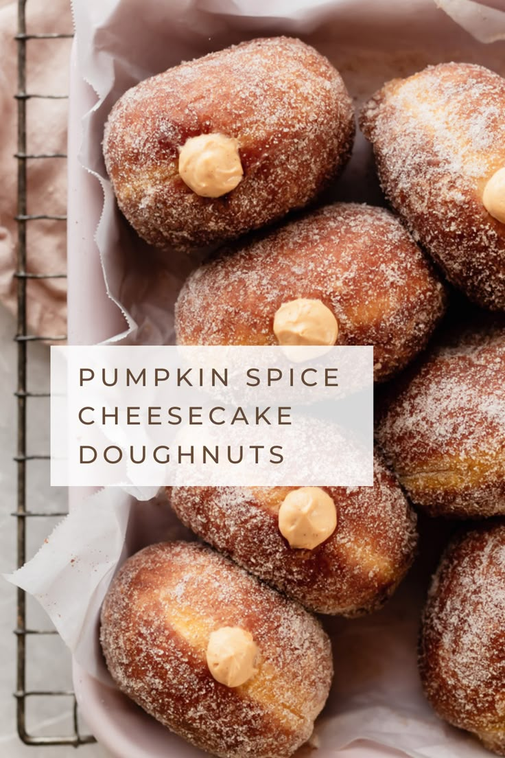 pumpkin spice cheesecake doughnuts in a basket with the words, pumpkin spice cheesecake doughnuts