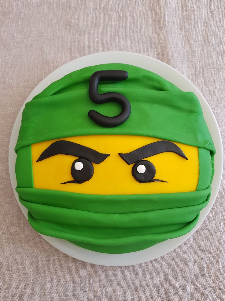 there is a cake made to look like a teenage mutant ninja's head with eyes and eyebrows