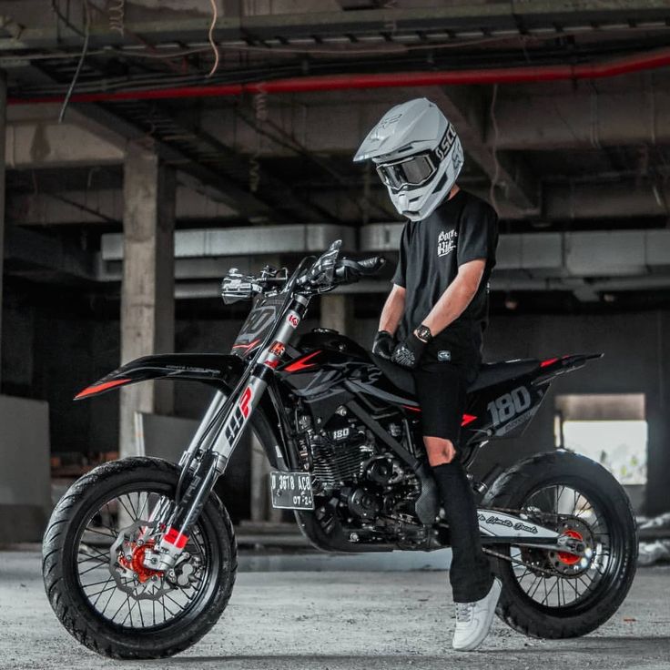 a man sitting on top of a dirt bike