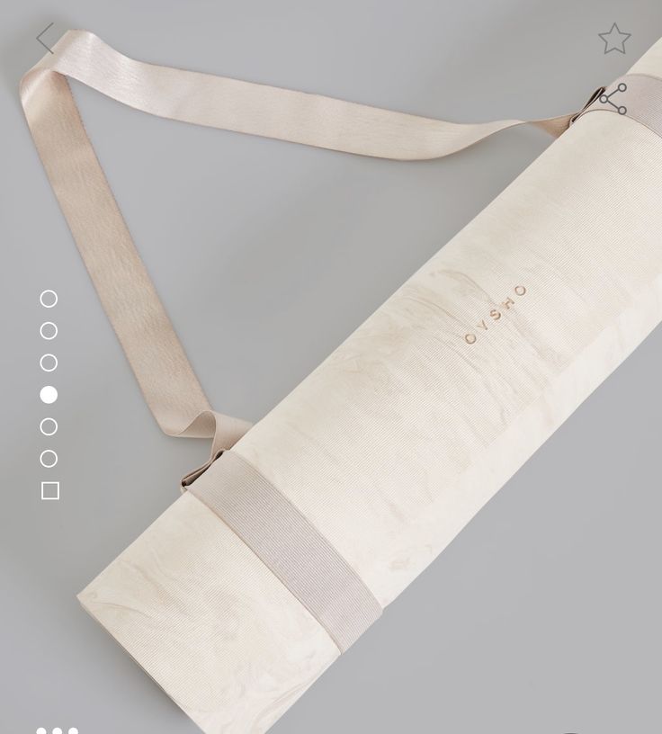 the back side of a yoga mat bag with straps attached to it, on a gray background