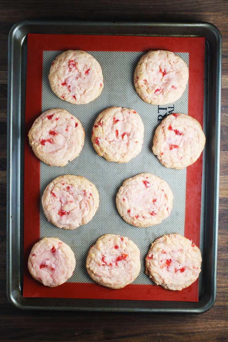 freshly baked strawberry cookies on a baking sheet