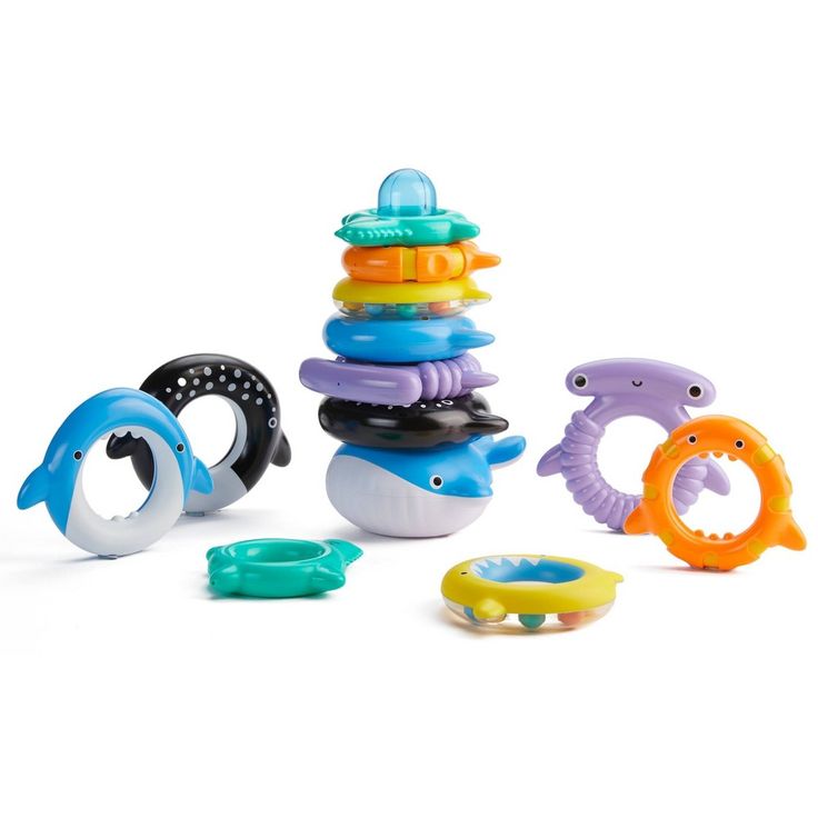 an assortment of baby toys sitting on top of each other in front of a white background