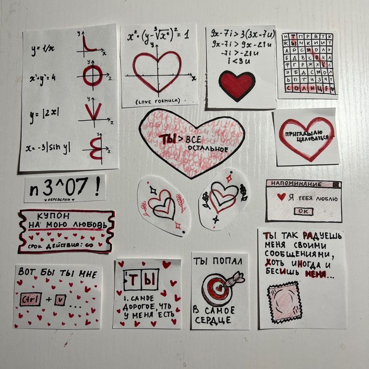 various stickers and decals are arranged on a refrigerator door in the shape of hearts