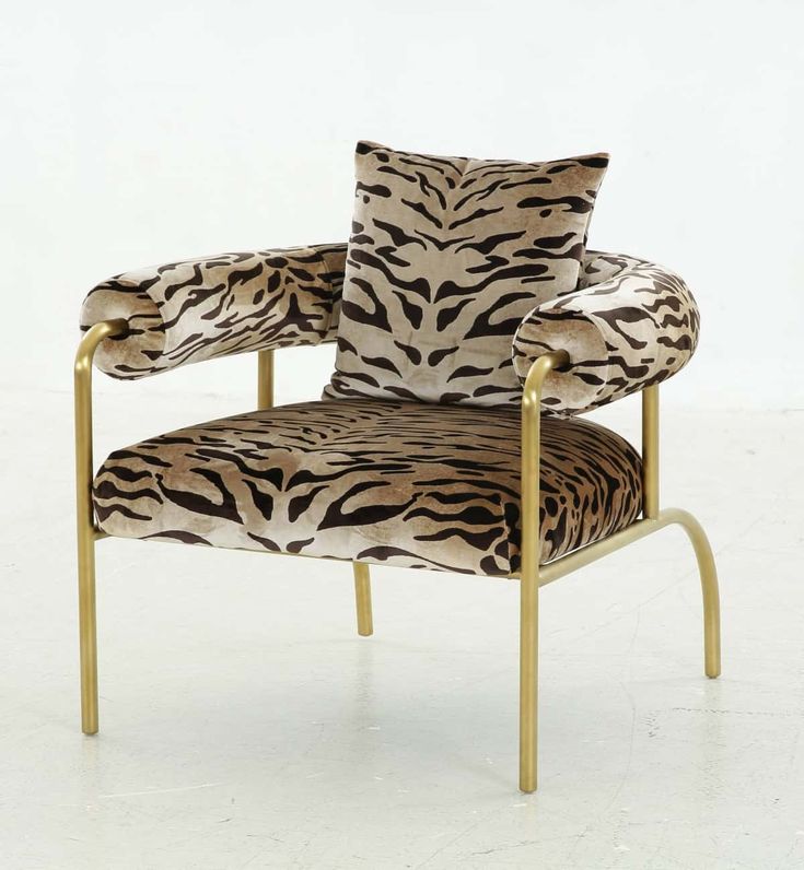 a zebra print chair with gold legs and arms