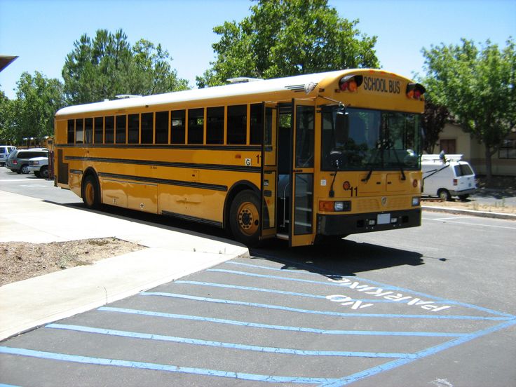 a yellow school bus parked in a parking lot