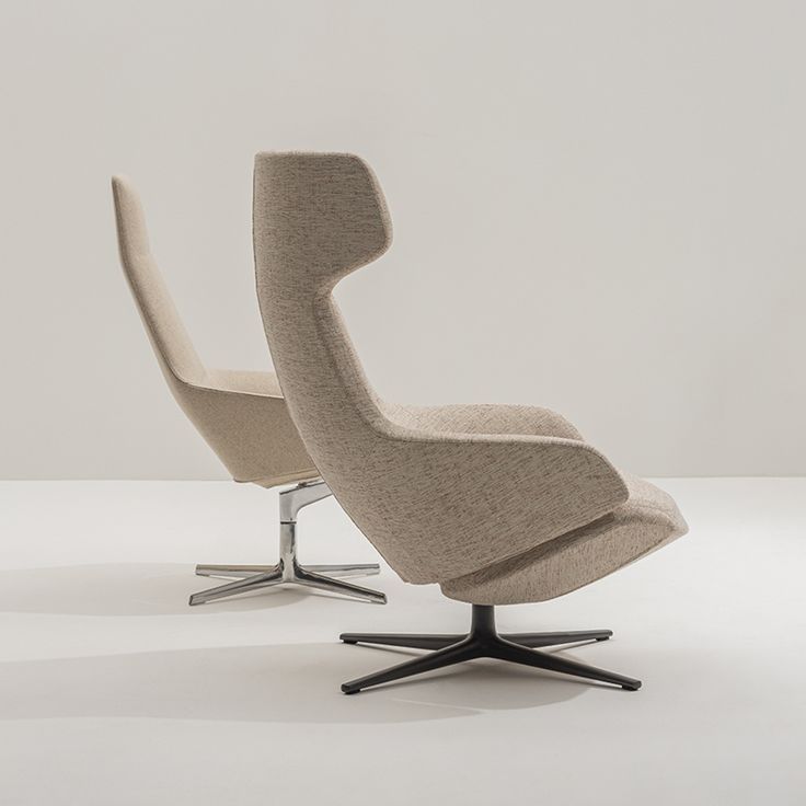 two modern chairs sitting side by side on top of a white floor with one chair facing the other