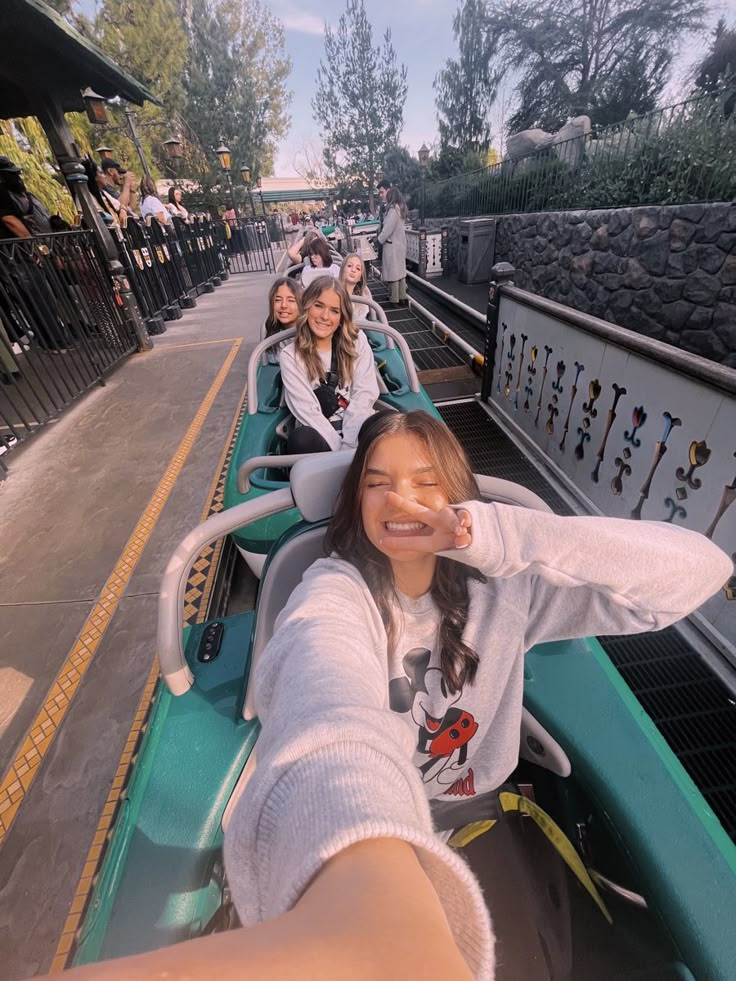 four girls are riding on a roller coaster