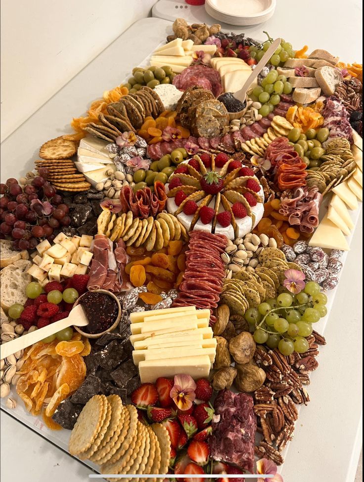 a table topped with lots of different types of cheese and crackers on top of it