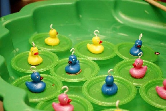 several rubber ducks are sitting in a green tray