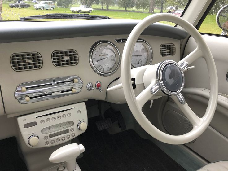 an interior view of a car with dashboard and gauges