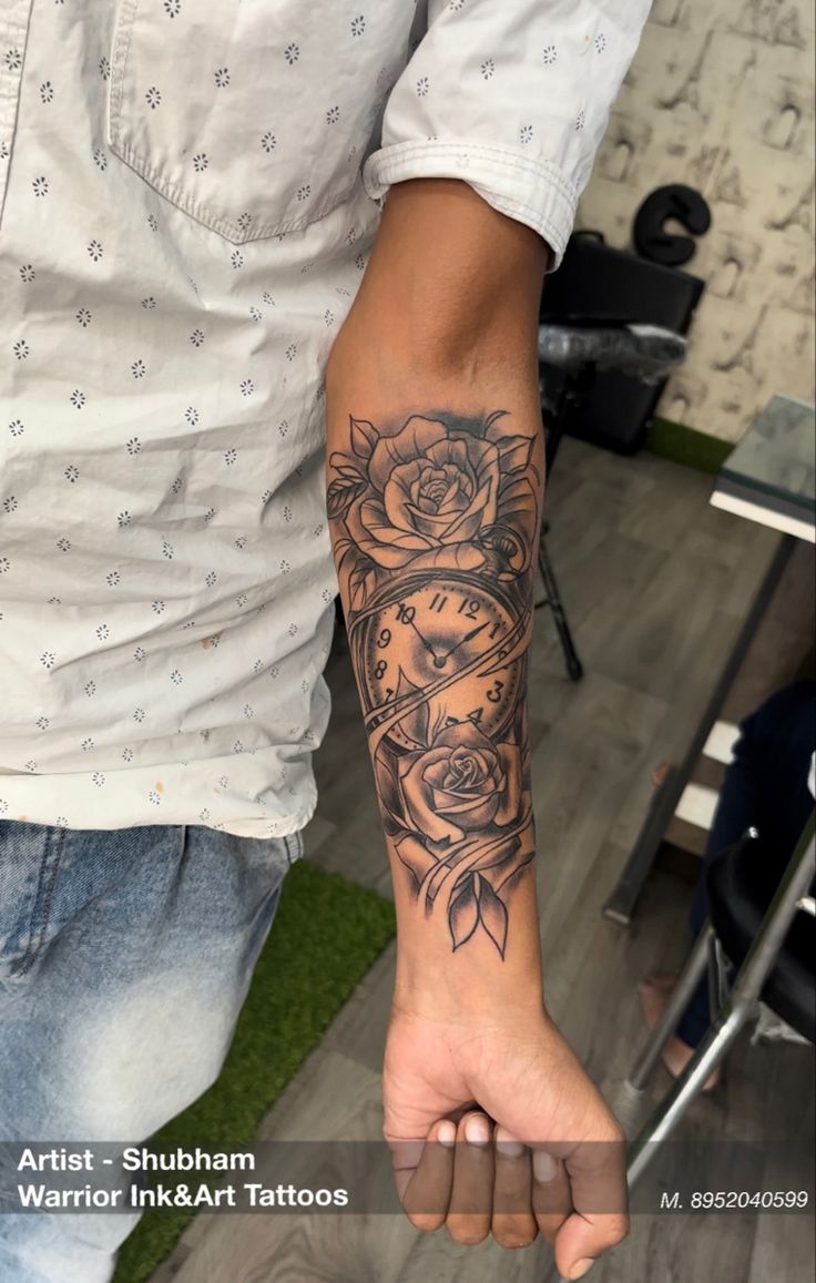 a man with a rose tattoo on his arm holding onto another person's hand