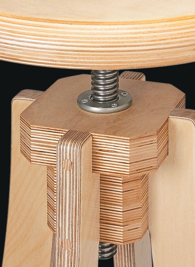 a close up of a wooden stool with a screw in the middle and wood grain