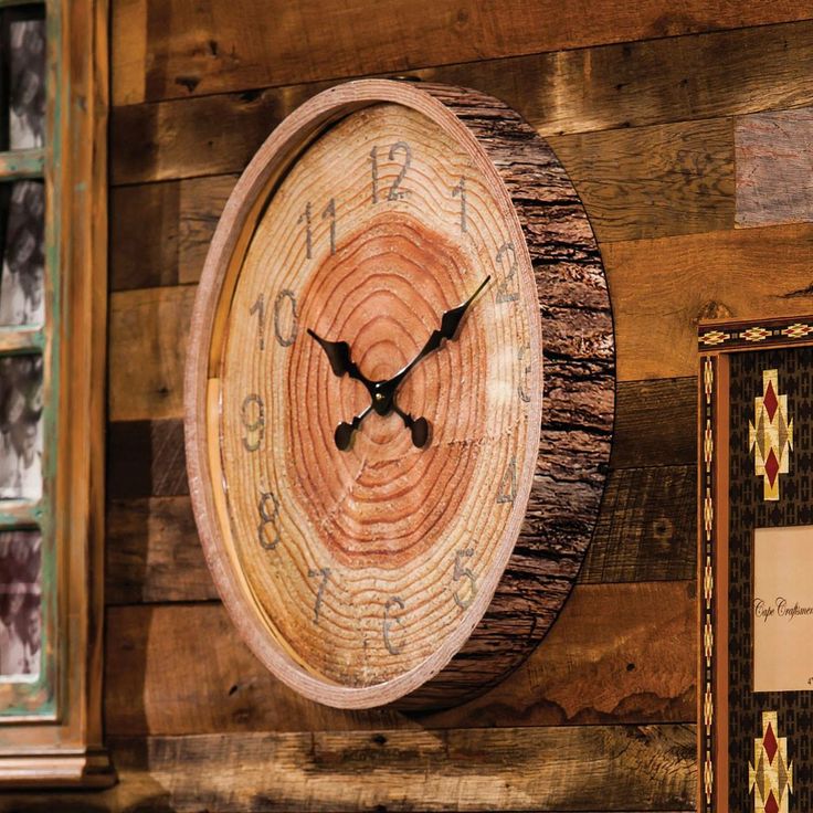 a wooden clock mounted to the side of a wall