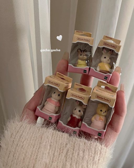 someone is holding five small teddy bears in their packages