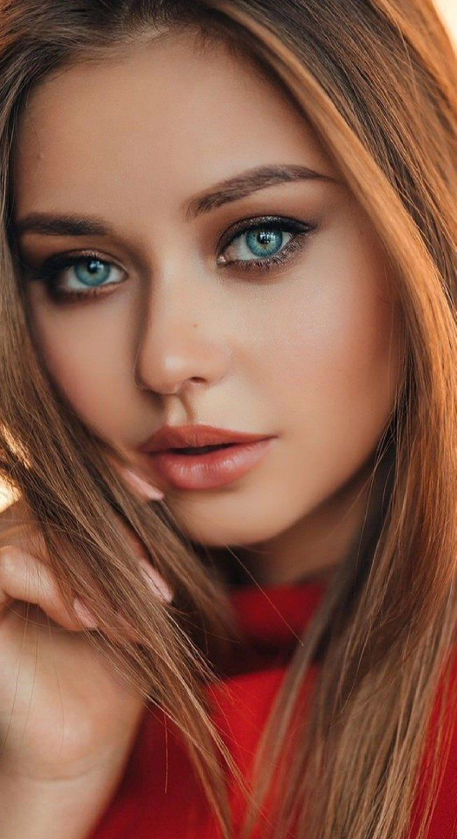 a beautiful young woman with blue eyes and long hair