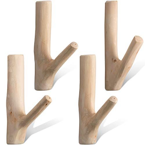 four wooden pegs in the shape of trees on a white background