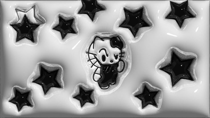 black and white photo of hello kitty cookies with stars around it in the shape of cats