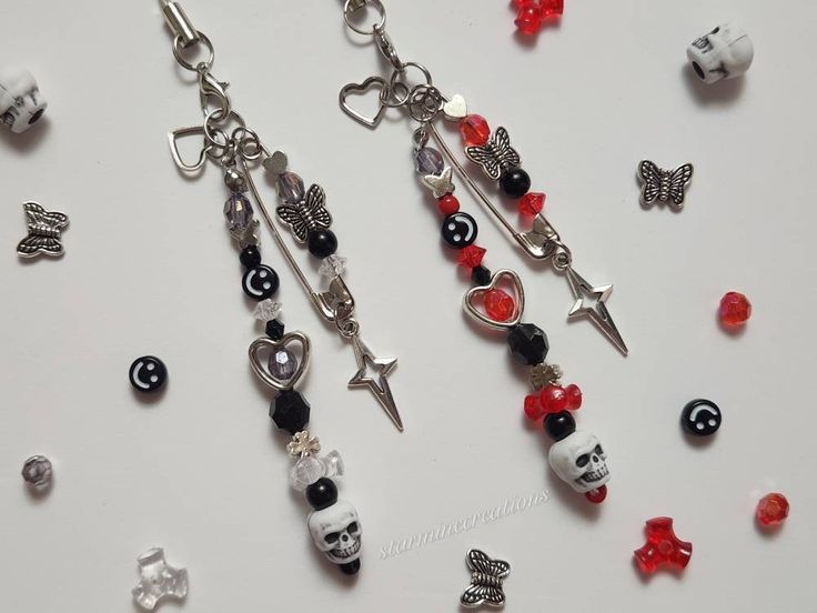 many different charms and beads on a white surface