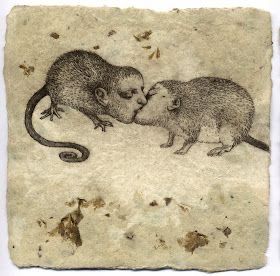 two small mouses are touching each other's noses on a piece of paper