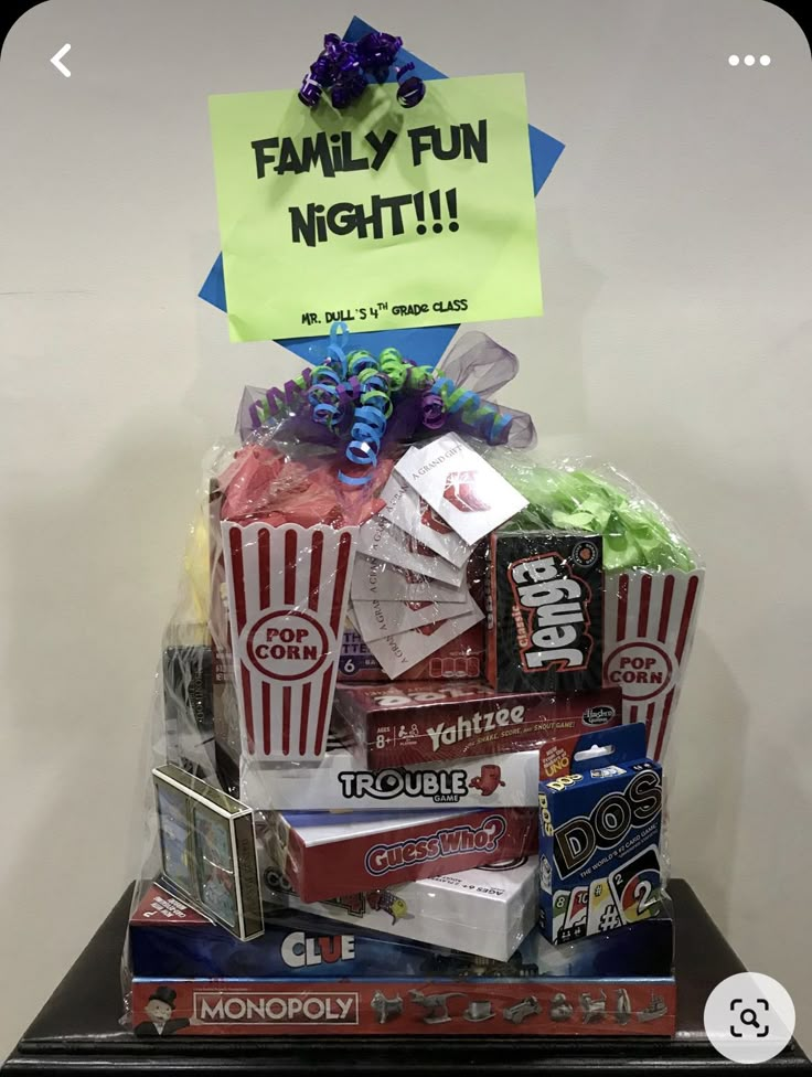 a pile of candy sitting on top of a wooden table next to a sign that says family fun night