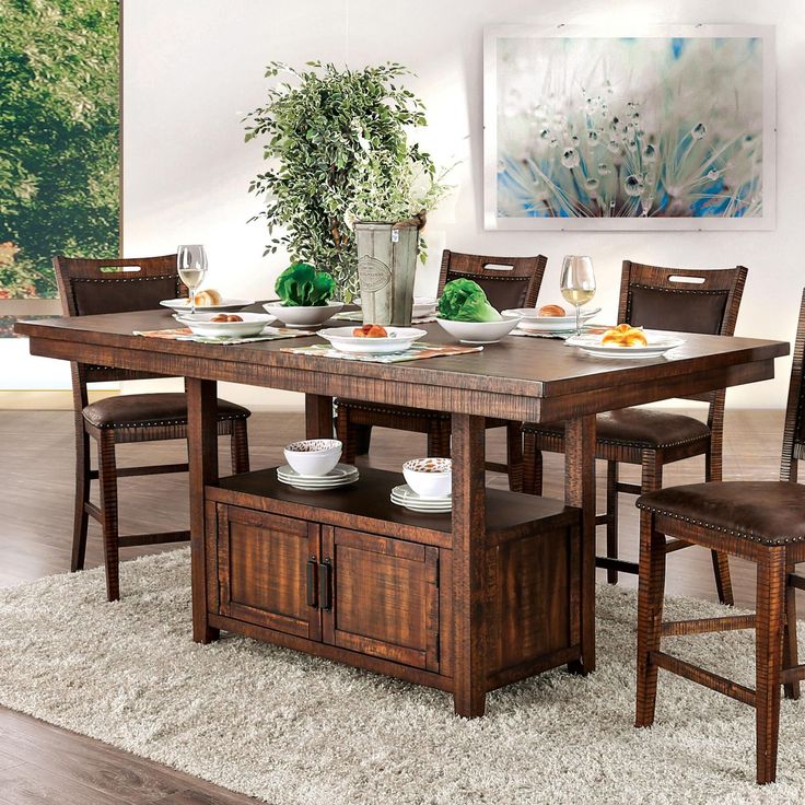 a dining room table and chairs with plates on it