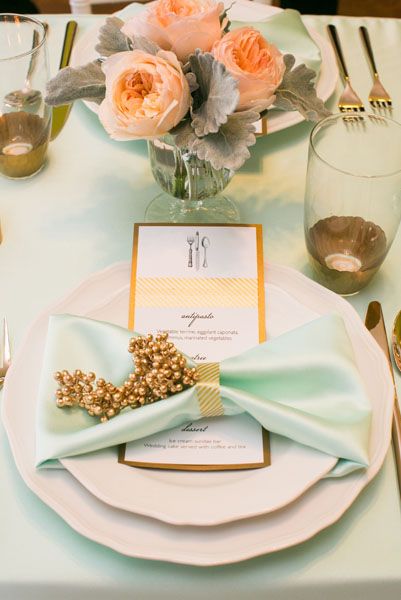 the table is set with flowers and place settings