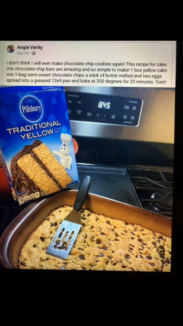 a pan filled with chocolate chip cake next to a box of crackers and a spatula