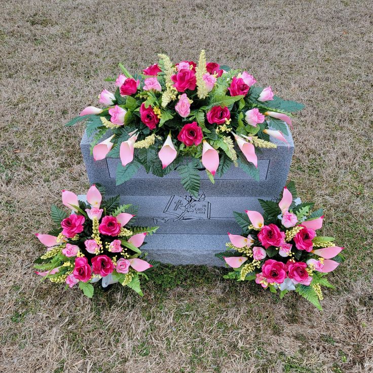 flowers are placed on the headstone of a grave in the middle of a field