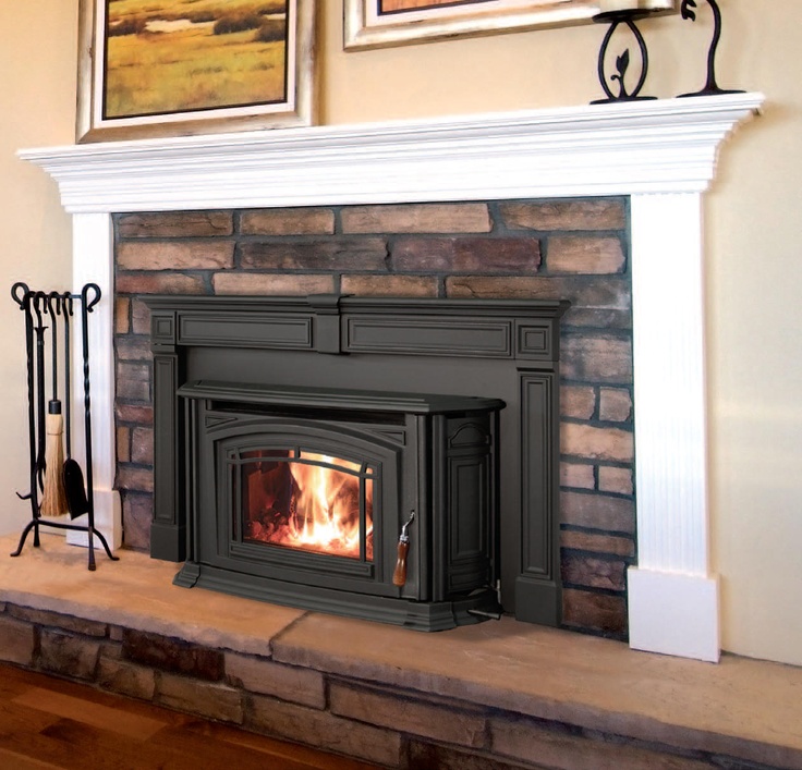 a fireplace with a fire burning in it's mantle next to a painting on the wall