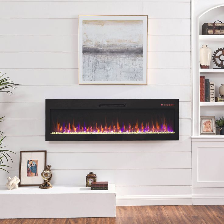 an electric fireplace in a living room with white walls