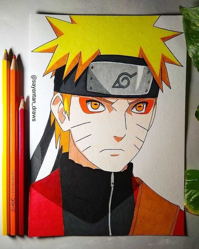 a drawing of naruto is shown with two pencils on the table next to it